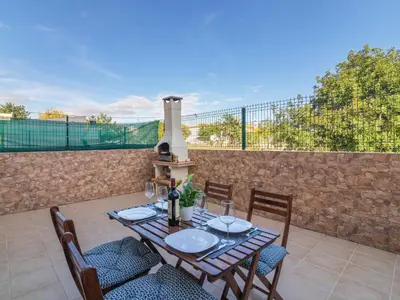 a table and chairs on a patio with a wall at Holiday Home Bela Vitta by Interhome in Ferreiras