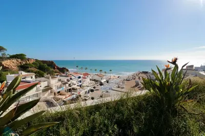 a beach with a bunch of umbrellas and the ocean at Olhos De Água 1BR with Pool, AC and Free Parking in Albufeira