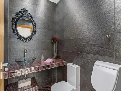 a bathroom with a sink and a toilet and a mirror at Stunning Luxury Villa Private Pool, Galé Albufeira in Albufeira