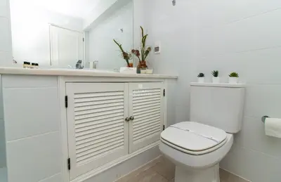 a white bathroom with a toilet and a sink at Blue Apartment Balaia Space - By Dalma Portuguesa in Albufeira