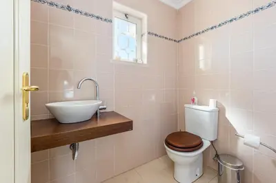 a bathroom with a toilet and a sink at Villa Cecília in Albufeira