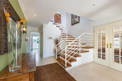 a staircase in a living room with a vase at Villa Cecília in Albufeira