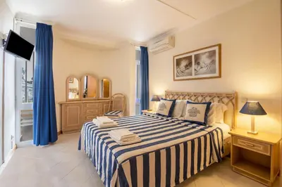 a bedroom with a large bed with blue curtains at Apartamento no Clube Praia da Oura in Albufeira
