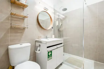 a bathroom with a toilet and a sink and a mirror at Praia Mar in Quarteira