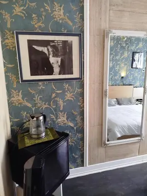 a bedroom with a wall mural of a city at São Pedro Suite Faro in Faro
