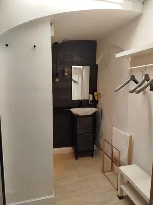 a small bedroom with a bed and a chair at São Pedro Suite Faro in Faro