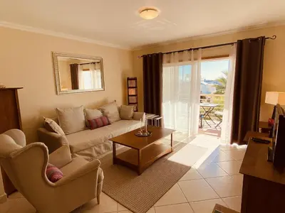a living room with a couch and a table at Vista by Check-in Portugal in Albufeira