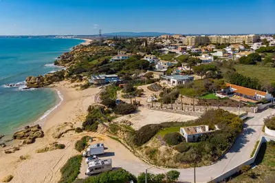 an aerial view of a beach with houses and the ocean at Casa Mimao in Albufeira