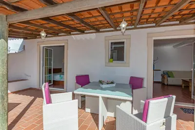 a dining room with a table and chairs at Casa Mimao in Albufeira