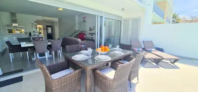 a dining table and chairs in a living room at Villa Modern Design in Albufeira