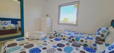 a bedroom with a bed and a mirror at Villa Modern Design in Albufeira