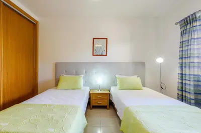 a bedroom with two beds and a night stand at Villa Protea - 5 bedroom, beach, air-con, wifi in Albufeira