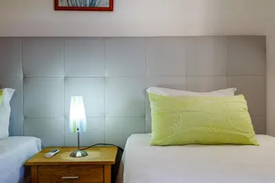 a bedroom with two beds and a lamp on a table at Villa Protea - 5 bedroom, beach, air-con, wifi in Albufeira