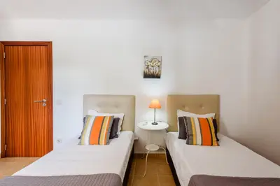 two beds sitting next to each other in a room at Villa Protea - 5 bedroom, beach, air-con, wifi in Albufeira