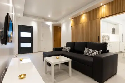 a living room with a black couch and a table at Correeira Luxury Residence in Albufeira