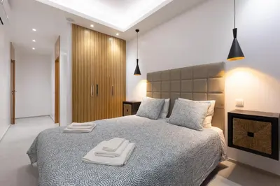 a bedroom with a bed with two towels on it at Correeira Luxury Residence in Albufeira