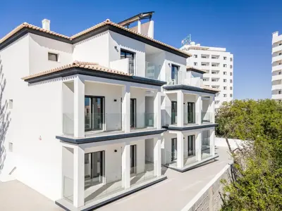 a white house with two floors at Correeira Luxury Residence in Albufeira