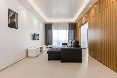 a living room with a black couch and a table at Correeira Luxury Residence in Albufeira