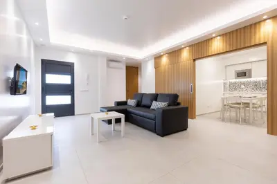 a living room with a black couch and a table at Correeira Luxury Residence in Albufeira