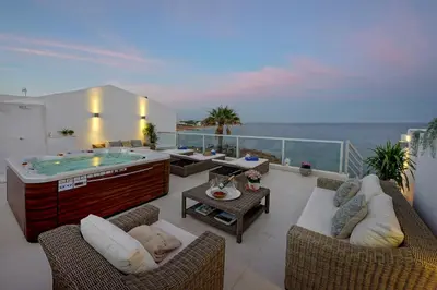 a living room with a hot tub on a balcony at Casa Latino - Oceanfront - Luxury & Charming villa- Jacuzzi at Rooftop by DreamvillasAlbufeira in Albufeira