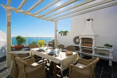 a dining room with a table and chairs and a fireplace at Casa Latino - Oceanfront - Luxury & Charming villa- Jacuzzi at Rooftop by DreamvillasAlbufeira in Albufeira
