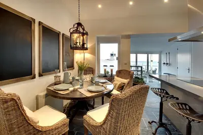 a kitchen and dining room with a table and chairs at Casa Latino - Oceanfront - Luxury & Charming villa- Jacuzzi at Rooftop by DreamvillasAlbufeira in Albufeira