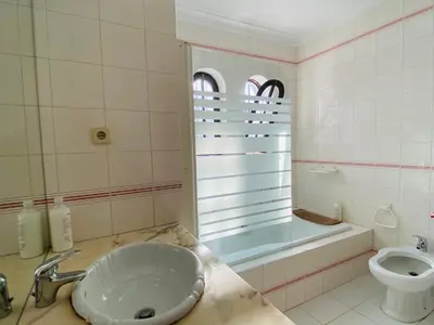 a bathroom with a sink and a tub and a toilet at Azinheira by Check-in Portugal in Albufeira