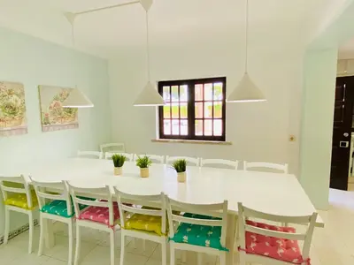 a white dining room with a white table and chairs at Azinheira by Check-in Portugal in Albufeira