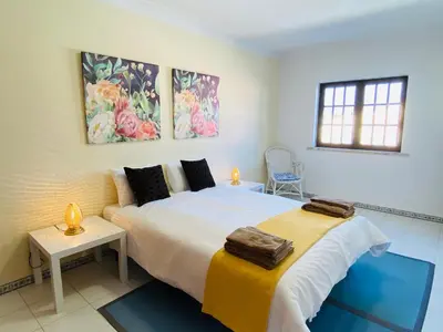 a bedroom with a large bed with two towels on it at Azinheira by Check-in Portugal in Albufeira