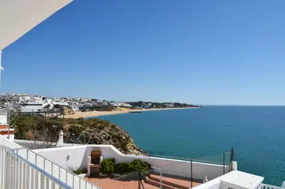 a view of the ocean from the balcony of a house at Apartamentos Encosta do Mar in Albufeira