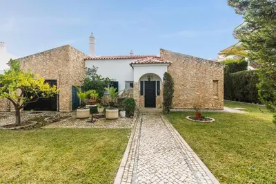 a stone house with a garden and a driveway at Oura Villa V3 com Piscina Privada in Albufeira