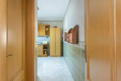 a kitchen with a hallway leading to a kitchenasteryasteryasteryasteryasteryasteryastery at Oura Villa V3 com Piscina Privada in Albufeira