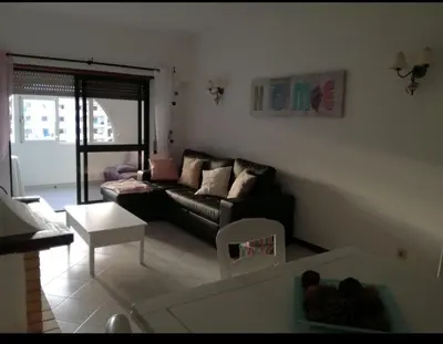 a living room with a couch and a table at Rêve au Soleil in Albufeira