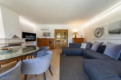 a living room with a blue couch and chairs at Villa Moises in Albufeira