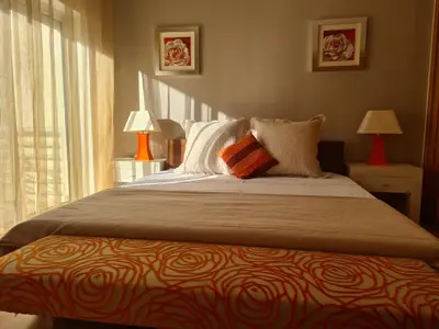 a bedroom with a bed with two lamps and a window at Vilamoura, Moura Praia in Quarteira