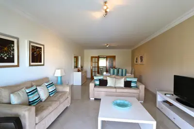 a living room with two couches and a tv at Vilamoura, Moura Praia in Quarteira