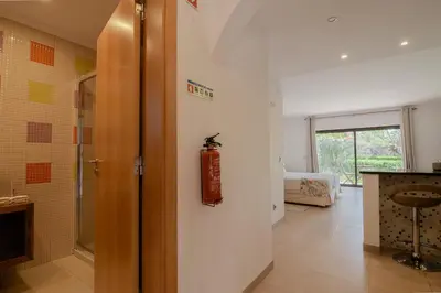 a bathroom with a fire extinguisher on the wall at Coastal Retreat with Pool and Beach Access by Drago Rentals in Albufeira