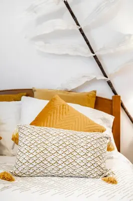 a bed with a pillow on top of it at Cosy by the pool in Quarteira