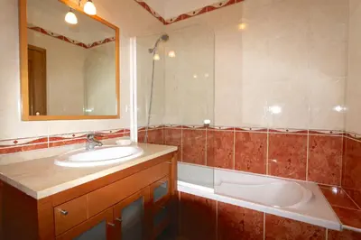 a bathroom with a sink and a tub and a mirror at Vilamoura, Marina Sol T2 in Vilamoura