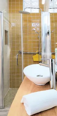 a bathroom with a white sink and a shower at Bambus House Blue in Quarteira