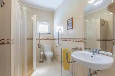 a bathroom with a sink and a toilet at Bambus House Blue in Quarteira