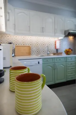 two cups sitting on a counter in a kitchen at Bambus House Green in Quarteira