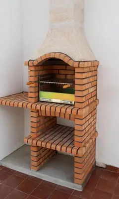 a brick oven sitting on top of a wall at Bambus House Green in Quarteira