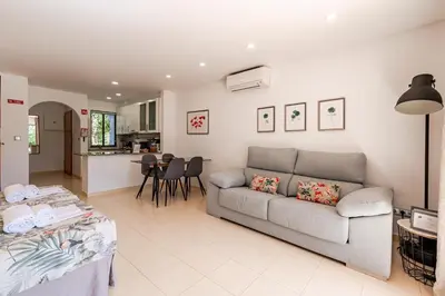 a living room with a couch and a kitchen at Seacoast Retreat with Pool and Beach Access by Drago Rentals in Albufeira