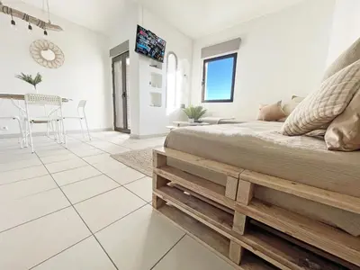 a bedroom with a bed and a dining room at Beachfront Oura - 100m Beach, Seaview, Garage, 300m Strip in Albufeira