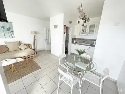 a living room with a glass table and chairs at Beachfront Oura - 100m Beach, Seaview, Garage, 300m Strip in Albufeira