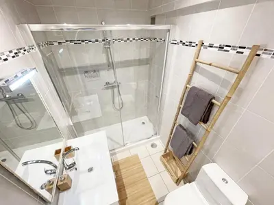 a bathroom with a shower and a toilet and a sink at Beachfront Oura - 100m Beach, Seaview, Garage, 300m Strip in Albufeira
