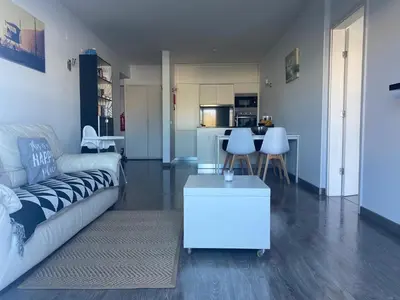 a living room with a couch and a table at Deluxe apartment in Albufeira old town, 200m walk to beach, pool parking in Albufeira