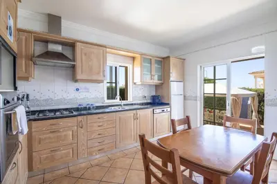 a bedroom with two beds and a dresser and a window at Villa Tulipa in Albufeira