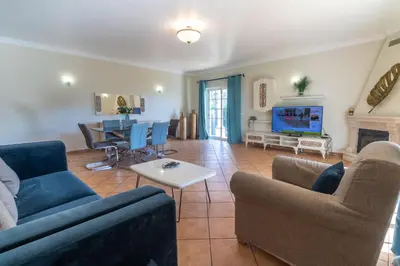 a living room with a couch and a table at Villa Tulipa in Albufeira